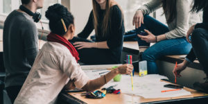 group of staff from diverse backgrounds in an office having a conversation