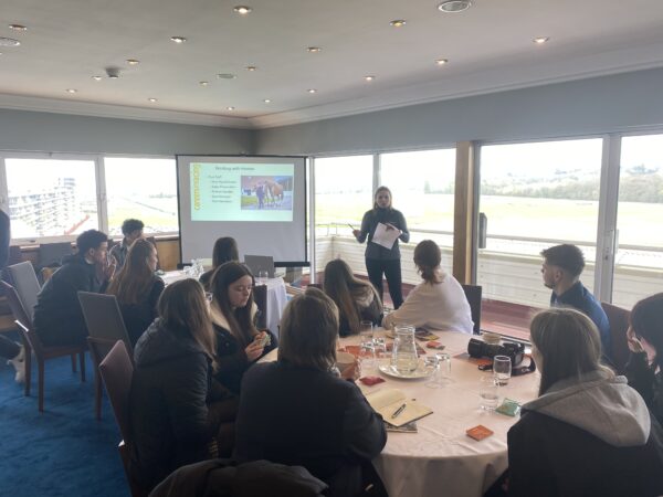 Explore career days at BHA Careers in racing, a photo of a group of people at an explore day, speaking around a table.