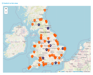 A map of the UK with orange and dark blue pins placed on specific locations.